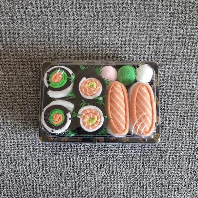 Sushi-shaped socks gift set in a plastic tray on a gray textured surface