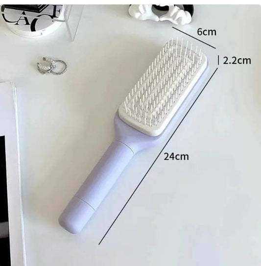 Rectangular paddle hair brush with measurements 24cm x 6cm x 2.2cm on a white desk
