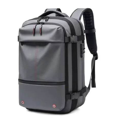 Modern gray travel backpack with black accents and padded straps against a white background.