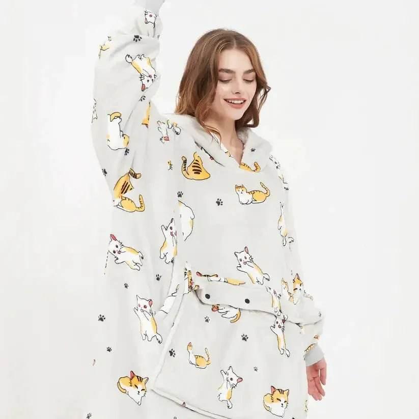 Woman wearing oversized hoodie blanket with cute cat print pattern and paw prints