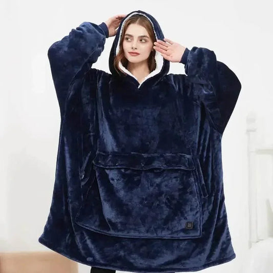Woman wearing oversized navy blue fleece hoodie blanket with front pocket indoors