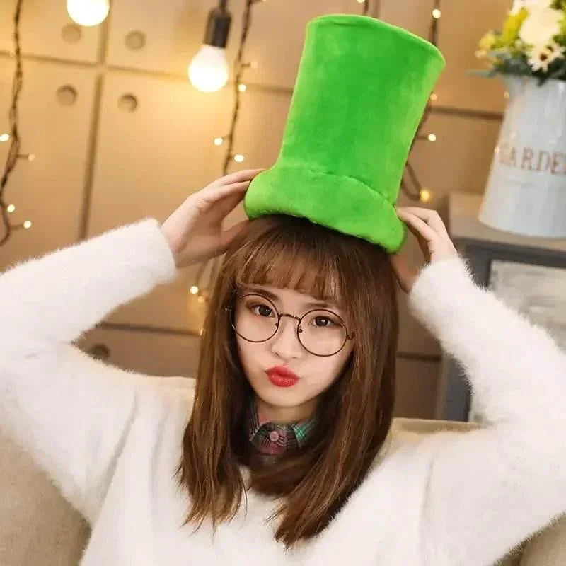 Woman with glasses wearing a fluffy green top hat indoors with fairy lights background