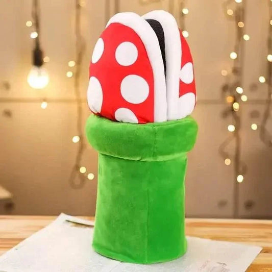 Plush piranha plant toy with red and white polka dots in green pipe on wooden table