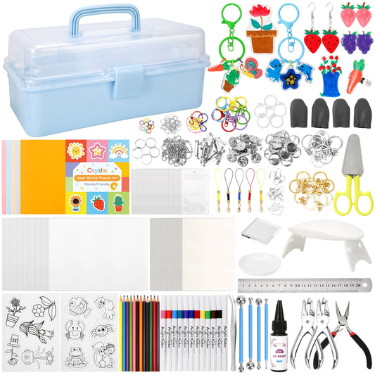 400-piece shrink art kit with storage case, shrink film sheets, markers, resin, UV light, and DIY craft accessories.