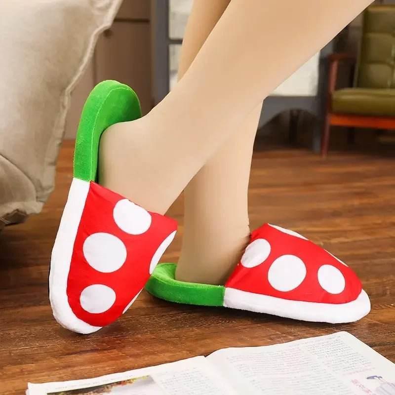 Red and white polka dot plush slippers with green trim on feet, cozy indoor setting