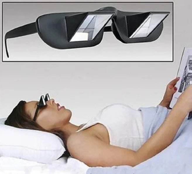 Woman lying in bed reading with black prism lazy glasses, close-up of eyewear inset