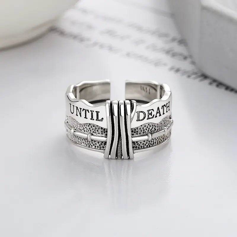 Silver engraved ring with 'UNTIL DEATH' text, unique texture, on white background